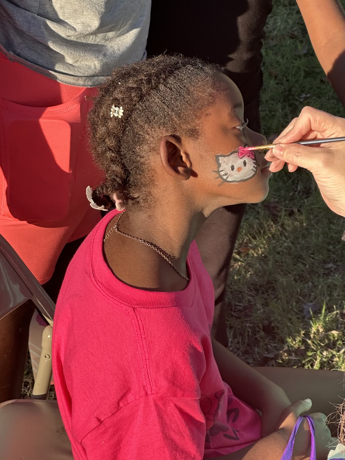 A child having their face painted at an SCC event