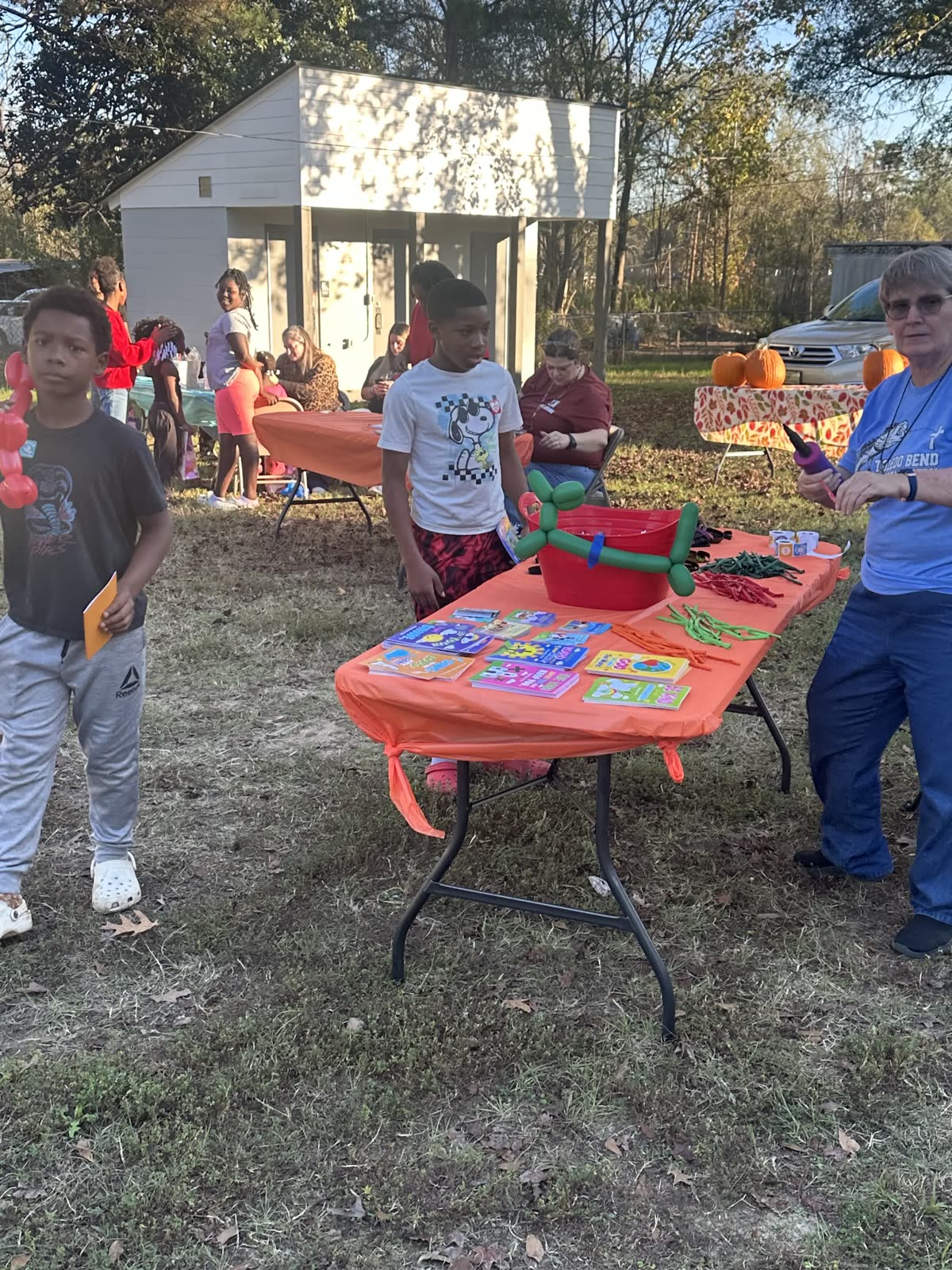 Children enjoying activities together at an outdoor fall event