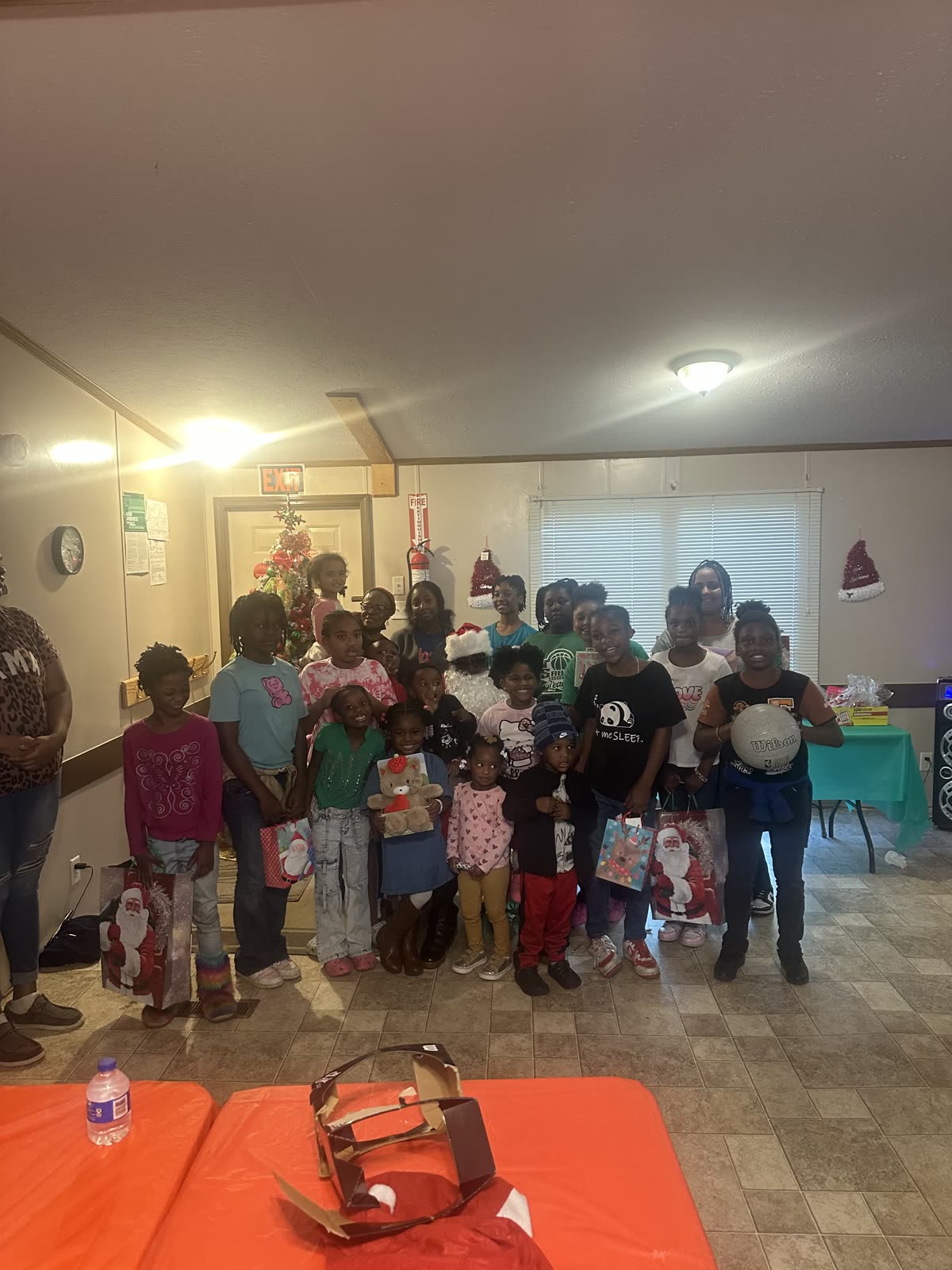 Children and volunteers gathered with Santa during an SCC holiday celebration